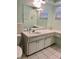 Bathroom featuring a vanity and an oversized mirror with dual windows for natural light at 5645 97Th N Way, St Petersburg, FL 33708