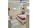 Bedroom with neutral colored walls, a ceiling fan, and an open bookcase for storage at 5645 97Th N Way, St Petersburg, FL 33708