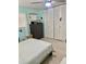 Bright bedroom with a ceiling fan, built-in closet, and a large dresser with a seashell mirror at 5645 97Th N Way, St Petersburg, FL 33708
