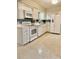 Bright kitchen with white appliances, stylish cabinetry, and ample counter space at 5645 97Th N Way, St Petersburg, FL 33708