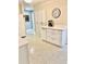 Kitchen area offering an island with white cabinets and a large pantry at 5645 97Th N Way, St Petersburg, FL 33708