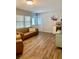 Comfortable living space with a leather sofa, wood floors, and natural light from the windows at 5645 97Th N Way, St Petersburg, FL 33708