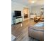 Spacious living area with an open floor plan, leather seating, and wood-look flooring at 5645 97Th N Way, St Petersburg, FL 33708
