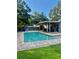 Inviting backyard oasis with a sparkling pool, comfortable seating, and a covered patio area at 5645 97Th N Way, St Petersburg, FL 33708