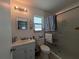 Clean bathroom featuring a glass-enclosed shower, toilet, vanity, and accessible grab bar at 5930 Bahama N Way, St Pete Beach, FL 33706