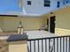 Inviting front porch with decorative lamp posts and space for outdoor seating to enjoy the beautiful views at 5930 Bahama N Way, St Pete Beach, FL 33706