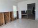 Bright living room with tile floors, featuring large window and open layout awaiting modern renovation and creative design at 5930 Bahama N Way, St Pete Beach, FL 33706