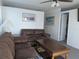 Comfortable living room with a leather sofa, carpeted floors, and a wooden coffee table at 5930 Bahama N Way, St Pete Beach, FL 33706