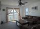 Living room with patio view and brown sofa at 5930 Bahama N Way, St Pete Beach, FL 33706