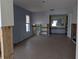 Open living space with tile flooring, ready for renovation, featuring a glimpse into the bathroom and natural light at 5930 Bahama N Way, St Pete Beach, FL 33706