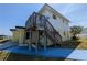 A two story home, featuring an outdoor deck and a stairway to the upper level at 5930 Bahama N Way, St Pete Beach, FL 33706