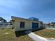 A side view of the two story home featuring the garage and a view of the canal at 5930 Bahama N Way, St Pete Beach, FL 33706