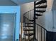 A classic spiral staircase with black iron railings is a distinctive architectural element at 5930 Bahama N Way, St Pete Beach, FL 33706