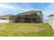 Spacious backyard with a screened-in pool and manicured lawn at 621 Washita Stone Dr, Ruskin, FL 33570