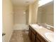 Bright bathroom featuring a shower-tub combo, dual sink vanity, and neutral tile flooring at 621 Washita Stone Dr, Ruskin, FL 33570