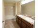 Bathroom with a shower over bath, double sink vanity, and neutral wall colors at 621 Washita Stone Dr, Ruskin, FL 33570
