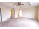 Expansive bedroom with a ceiling fan, closet, and views of additional rooms; neutral carpet at 621 Washita Stone Dr, Ruskin, FL 33570