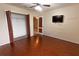 Bedroom with wood floors, ceiling fan, and walk-in closet at 621 Washita Stone Dr, Ruskin, FL 33570