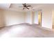 Large bedroom with tray ceiling, ceiling fan, and views into other rooms, with neutral carpet at 621 Washita Stone Dr, Ruskin, FL 33570