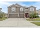 Charming two-story home with a three-car garage and a well-manicured lawn at 621 Washita Stone Dr, Ruskin, FL 33570