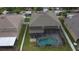 Aerial view of home with screened-in pool and well-maintained yard at 621 Washita Stone Dr, Ruskin, FL 33570