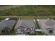 Aerial view of a two-story home with a well-manicured lawn and a two car garage at 621 Washita Stone Dr, Ruskin, FL 33570