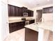 Stylish kitchen with granite counters, stainless steel appliances, and dark wood cabinetry at 621 Washita Stone Dr, Ruskin, FL 33570
