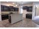 A bright and stylish kitchen with a large island and tile flooring at 621 Washita Stone Dr, Ruskin, FL 33570