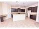 Open kitchen featuring granite countertops, stainless steel appliances, and dark wood cabinets at 621 Washita Stone Dr, Ruskin, FL 33570