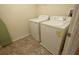 Compact laundry room with washer, dryer, and tile floors; functional and ready for use at 621 Washita Stone Dr, Ruskin, FL 33570