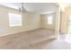 Spacious living room with neutral carpet, chandelier lighting, and bright natural light at 621 Washita Stone Dr, Ruskin, FL 33570
