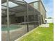A screened-in pool with a green lawn leading to the house at 621 Washita Stone Dr, Ruskin, FL 33570