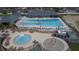 Aerial view of community pool with lounge chairs, tables, and splash pad for Gathering fun at 621 Washita Stone Dr, Ruskin, FL 33570