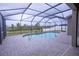 Outdoor living with a screened-in pool and brick pavers at 621 Washita Stone Dr, Ruskin, FL 33570