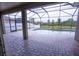 Relaxing screened-in pool area with brick pavers and views of green space at 621 Washita Stone Dr, Ruskin, FL 33570