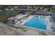 Community pool and splashpad with lounge chairs, umbrellas, and a basketball court nearby at 621 Washita Stone Dr, Ruskin, FL 33570