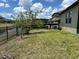 Backyard with manicured lawn, pond access and a fence, creating an ideal outdoor space at 6244 English Hollow Rd, Tampa, FL 33647