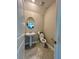 This bathroom features a pedestal sink, oval mirror, tile floors, and modern fixtures at 6244 English Hollow Rd, Tampa, FL 33647