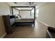 Bedroom with wood floors, a four-poster bed, and natural light from the window at 6244 English Hollow Rd, Tampa, FL 33647