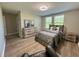 Cozy bedroom boasts natural light, wood floors, neutral tones, and ample closet space at 6244 English Hollow Rd, Tampa, FL 33647