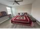 Bedroom with ceiling fan, and wood floor with area rug covering the hardwood flooring at 6244 English Hollow Rd, Tampa, FL 33647