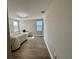 Bright bedroom featuring hardwood floors, a ceiling light, and natural light at 6244 English Hollow Rd, Tampa, FL 33647