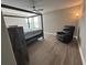 Bedroom with a four-poster bed, a ceiling fan, wood-look flooring and easy chair at 6244 English Hollow Rd, Tampa, FL 33647
