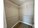 Walk-in closet with metal shelving and wood floors, perfect for organization at 6244 English Hollow Rd, Tampa, FL 33647