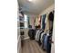 Walk-in closet featuring metal shelving and bars for ample storage space and organization at 6244 English Hollow Rd, Tampa, FL 33647