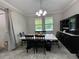 Charming dining room with black dining set, a buffet, and natural light through the windows at 6244 English Hollow Rd, Tampa, FL 33647