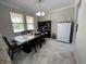 Bright dining room with a view of the kitchen featuring a dining set and a buffet at 6244 English Hollow Rd, Tampa, FL 33647