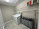 A laundry room with washer, dryer, and overhead shelving at 6244 English Hollow Rd, Tampa, FL 33647