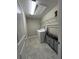 Laundry room with a washer, dryer, storage shelves, and tile flooring at 6244 English Hollow Rd, Tampa, FL 33647