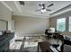 Bright home office with marble floors, crown molding, and a ceiling fan at 6244 English Hollow Rd, Tampa, FL 33647